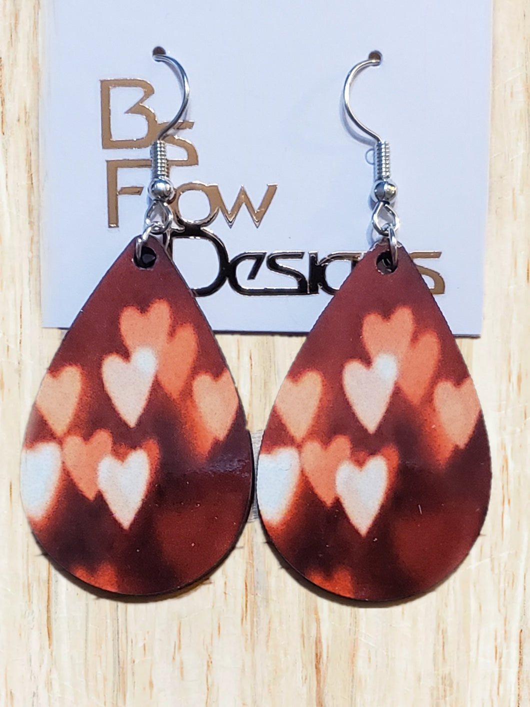 Elongated Pink Hearts Deep Red Background Earrings